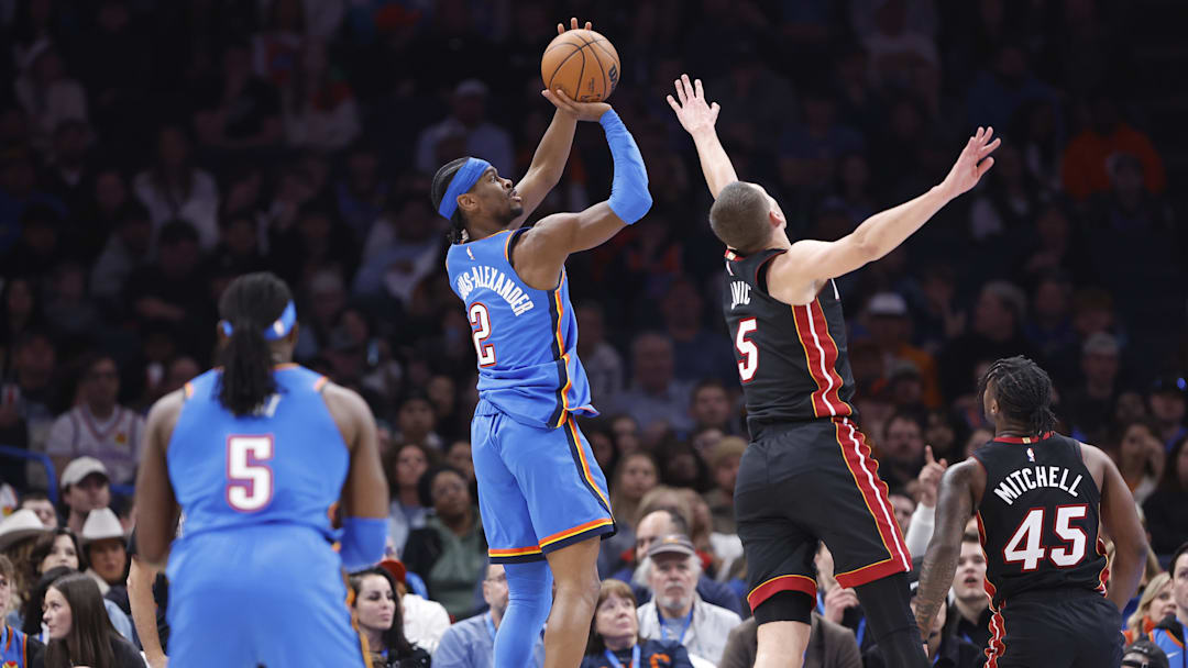 Feb 12, 2025; Oklahoma City, Oklahoma, USA; Oklahoma City Thunder guard Shai Gilgeous-Alexander (2) shoots as Miami Heat forward Nikola Jovic (5) defends during the second quarter at Paycom Center. Mandatory Credit: Alonzo Adams-Imagn Images