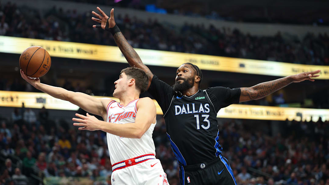 Jan 3, 2026; Dallas, Texas, USA;  Houston Rockets guard Reed Sheppard (15) drives to the basket past Dallas Mavericks forward Naji Marshall (13) during the first quarter at American Airlines Center. Mandatory Credit: Kevin Jairaj-Imagn Images