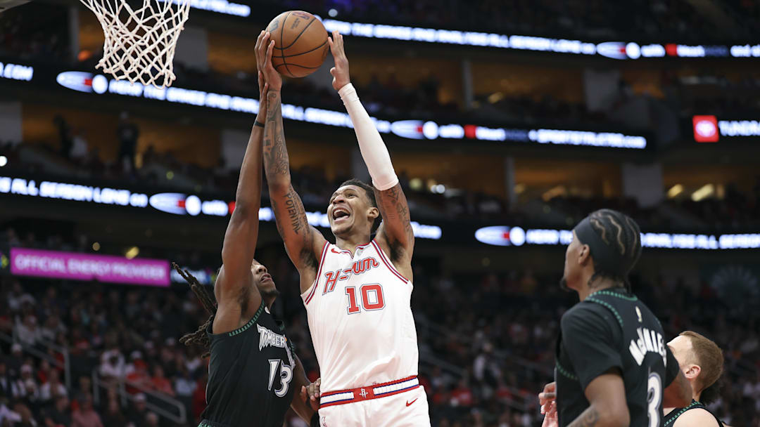 Apr 10, 2026; Houston, Texas, USA; Houston Rockets forward Jabari Smith Jr. (10) attempts to score a basket as Minnesota Timberwolves guard Ayo Dosunmu (13) defends during the third quarter at Toyota Center. Mandatory Credit: Troy Taormina-Imagn Images