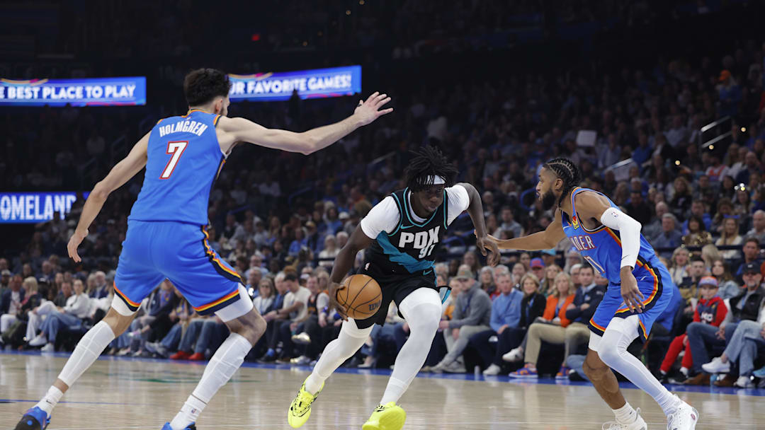 Dec 31, 2025; Oklahoma City, Oklahoma, USA; Portland Trail Blazers guard Sidy Cissoko (91) drives between Oklahoma City Thunder center Chet Holmgren (7) and guard Isaiah Joe (11) during the second quarter at Paycom Center. Mandatory Credit: Alonzo Adams-Imagn Images