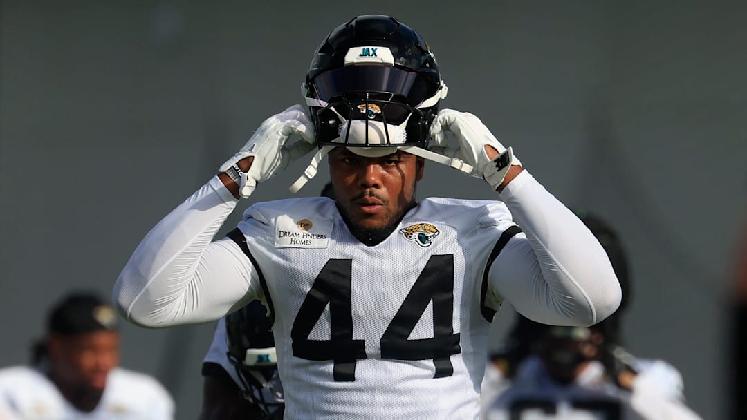 Jacksonville Jaguars defensive end Travon Walker (44) puts on his helmet during an NFL training camp session at the Miller Electric Center, Friday, July 25, 2025, in Jacksonville, Fla. [Corey Perrine/Florida Times-Union]