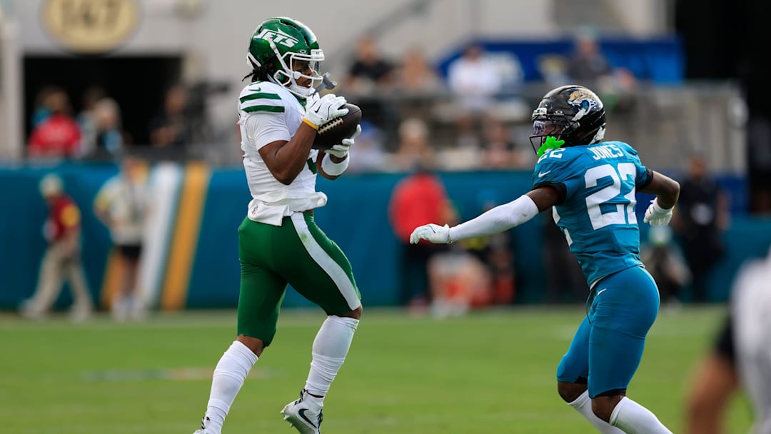 New York Jets wide receiver John Metchie III (3) catches a pass as Jacksonville Jaguars cornerback Jourdan Lewis (2) looks on during the fourth quarter of an NFL football matchup at EverBank Stadium, Sunday, Dec. 14, 2025, in Jacksonville, Fla. The Jaguars defeated the Jets 48-20. [Corey Perrine/Florida Times-Union]