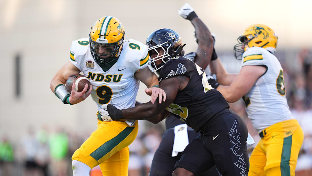 Aug 29, 2024; Boulder, Colorado, USA; Colorado Buffaloes linebacker LaVonta Bentley (20) tackles North Dakota State Bison quarterback Cole Payton (9) in the first half at Folsom Field. Mandatory Credit: Ron Chenoy-Imagn Images