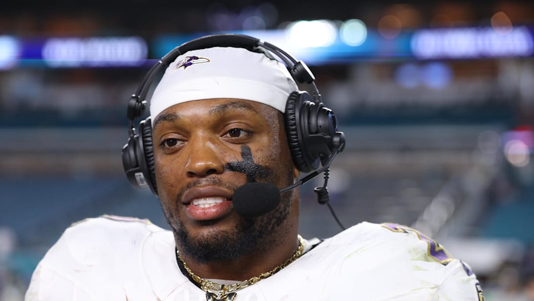 Oct 30, 2025; Miami Gardens, Florida, USA; Baltimore Ravens running back Derrick Henry (22) wears a butterfly necklace during a postgame interview following a win over the Miami Dolphins at Hard Rock Stadium. Mandatory Credit: Nathan Ray Seebeck-Imagn Images