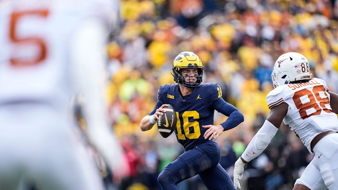 Michigan quarterback Davis Warren (16) looks to makes a pass against Texas linebacker Barryn Sorrell (88) during the second half at Michigan Stadium in Ann Arbor on Saturday, September 7, 2024.