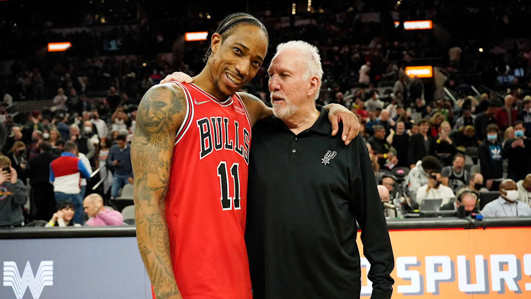 Jan 28, 2022; San Antonio, Texas, USA; Chicago Bulls guard DeMar DeRozan (11) hugs San Antonio Spurs head coach Gregg Popovich after the game at AT&T Center. 