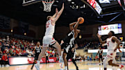 Nov 27, 2025; San Diego, CA, USA; Providence Friars forward Jamier Jones (5) shoots the ball against Wisconsin Badgers forward Aleksas Bieliauskas (32) during the first half at Jenny Craig Pavilion.