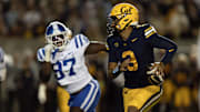 Oct 4, 2025; Berkeley, California, USA; California Golden Bears quarterback Jaron-Keawe Sagapolutele (3) scrambles away from pressure by Duke Blue Devils defensive end Wesley Williams (97) during the second quarter at California Memorial Stadium. Mandatory Credit: D. Ross Cameron-Imagn Images