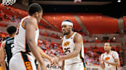 Feb 25, 2025; Stillwater, Oklahoma, USA; Oklahoma State Cowboys forward Robert Jennings II (25) slaps hands with Oklahoma State Cowboys forward Abou Ousmane (33) after a play during the first half against the Iowa State Cyclones at Gallagher-Iba Arena. Mandatory Credit: William Purnell-Imagn Images