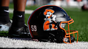 An Oklahoma State helmet is pictured before a college football game between the Oklahoma State Cowboys (OSU) and the Houston Cougars at Boone Pickens Stadium in Stillwater, Okla., Saturday, Oct. 11, 2025.