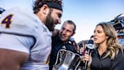 Nov 30, 2024; Tucson, Arizona, USA; Arizona State Sun Devils running back Cam Skattebo (4) holds the Territorial Cup alongside Arizona State Sun Devils head coach Kenny Dillingham at the end of the game against the Arizona Wildcats at Arizona Stadium. Mandatory Credit: Aryanna Frank-Imagn Images