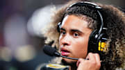 Oct 20, 2023; Carrollton, GA, USA; Carrollton Trojans quarterback Julian Lewis (10) watches on from the sidelines against the Westlake Lions during the first half at Grisham Stadium. The 15-year-old Carrollton High student has already committed to playing for the University of Southern California Trojans and has been considered one of the top high school quarterback prospects. Mandatory Credit: John David Mercer-Imagn Images