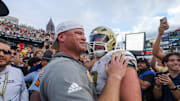 Nov 9, 2024; Atlanta, Georgia, USA; Georgia Tech Yellow Jackets head coach Brent Key hugs offensive lineman Weston Franklin (72) after a victory over the Miami Hurricanes at Bobby Dodd Stadium at Hyundai Field. Mandatory Credit: Brett Davis-Imagn Images