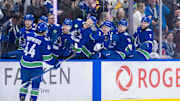 Dec 16, 2024; Vancouver, British Columbia, CAN; Vancouver Canucks forward Kiefer Sherwood (44) celebrates his third goal of the game with the bench against the Colorado Avalanche during the third period at Rogers Arena. Mandatory Credit: Bob Frid-Imagn Images