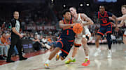 Dec 3, 2025; Austin, Texas, USA; Virginia Cavaliers guard Mark Thomas (1) drives the ball against Texas Longhorns guard Chendall Weaver (2) during the second half at Moody Center. Mandatory Credit: Dustin Safranek-Imagn Images