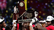 Dec 2, 2023; Atlanta, GA, USA; The Alabama Crimson Tide celebrate with the SEC championship trophy after defeating the Georgia Bulldogs at Mercedes-Benz Stadium. Mandatory Credit: John David Mercer-Imagn Images