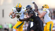 Colorado Buffaloes linebacker LaVonta Bentley tackles North Dakota State Bison quarterback Cole Payton 