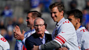 Oct 17, 2021; East Rutherford, NJ, USA;  New York Giants former head coach Tom Coughlin and quarterback Eli Manning hug during the ceremony honoring the Super Bowl XLVI winning team.  