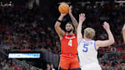 Illinois guard Kylan Boswell (4) hits a three-point basket over Kentucky guard Collin Chandler (5) during the second half of their second round NCAA men’ s basketball tournament game Sunday, March 23, 2025 at Fiserv Forum in Milwaukee, Wisconsin. Kentucky beat Illinois 84-75.