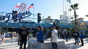 Apr 15, 2024; Los Angeles, California, USA;  Fans gather around Jackie Robinson statue at Dodger Stadium.