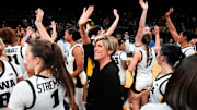 Iowa head coach Jan Jensen and her team wave to the Hawkeye fans Oct. 30, 2025 after defeating the Ashland Eagles in an exhibition game at Carver-Hawkeye Arena in Iowa City, Iowa.