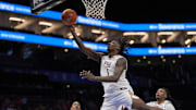 Mar 11, 2025; Charlotte, NC, USA; Florida State Seminoles guard Jamir Watkins (1) drives to the basket against the Syracuse Orange during the second half at Spectrum Center.