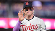 Jul 26, 2025; Minneapolis, Minnesota, USA; Minnesota Twins left fielder Harrison Bader (12) waves at a fan while walking to the dugout after the ninth inning against the Washington Nationals at Target Field. Mandatory Credit: Matt Blewett-Imagn Images