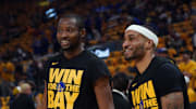 May 10, 2025; San Francisco, California, USA; Golden State Warriors forward Jonathan Kuminga (00) and guard Gary Payton II (0) warm up before game three of the second round for the 2025 NBA Playoffs against the Minnesota Timberwolves at Chase Center. Mandatory Credit: David Gonzales-Imagn Images