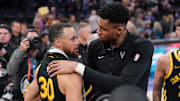 Milwaukee Bucks forward Giannis Antetokounmpo (34) and Golden State Warriors guard Stephen Curry (30) meet after the game at the Chase Center. 