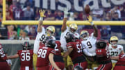 Notre Dame Fighting Irish defensive lineman Rylie Mills (99) defensive lineman Howard Cross III (56) and defensive lineman Justin Ademilola (9) can't stop a field goal from South Carolina Gamecocks place kicker Mitch Jeter (98) during the second quarter of the TaxSlayer Gator Bowl of an NCAA college football game Friday, Dec. 30, 2022 at TIAA Bank Field in Jacksonville.  