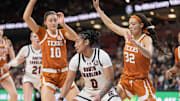 South Carolina Gamecocks guard Te-Hina Paopao moves on the court defended by Texas Longhorns guard Shay Holle and guard Ndjakalenga Mwenentanda