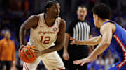 Jan 18, 2025; Gainesville, Florida, USA; Texas Longhorns guard Tramon Mark (12) looks to pass away from Florida Gators guard Walter Clayton Jr. (1) during the first half at Exactech Arena at the Stephen C. O'Connell Center. Mandatory Credit: Matt Pendleton-Imagn Images