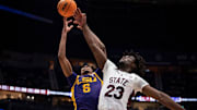 LSU Tigers forward Robert Miller III (6) and Mississippi State Bulldogs center Michael Nwoko (23) go for a rebound during their first round game of the SEC Men's Basketball Tournament at Bridgestone Arena in Nashville, Tenn., Wednesday, March 12, 2025.