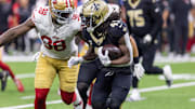 Sep 14, 2025; New Orleans, Louisiana, USA;  San Francisco 49ers defensive end Mykel Williams (98) tackles New Orleans Saints running back Alvin Kamara (41) during the second half at Caesars Superdome. Mandatory Credit: Stephen Lew-Imagn Images