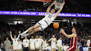 Feb 7, 2024; Evanston, Illinois, USA; Northwestern Wildcats guard Brooks Barnhizer (13) dunks the ball on Nebraska Cornhuskers guard Keisei Tominaga (30) during the second half at Welsh-Ryan Arena. Mandatory Credit: David Banks-Imagn Images