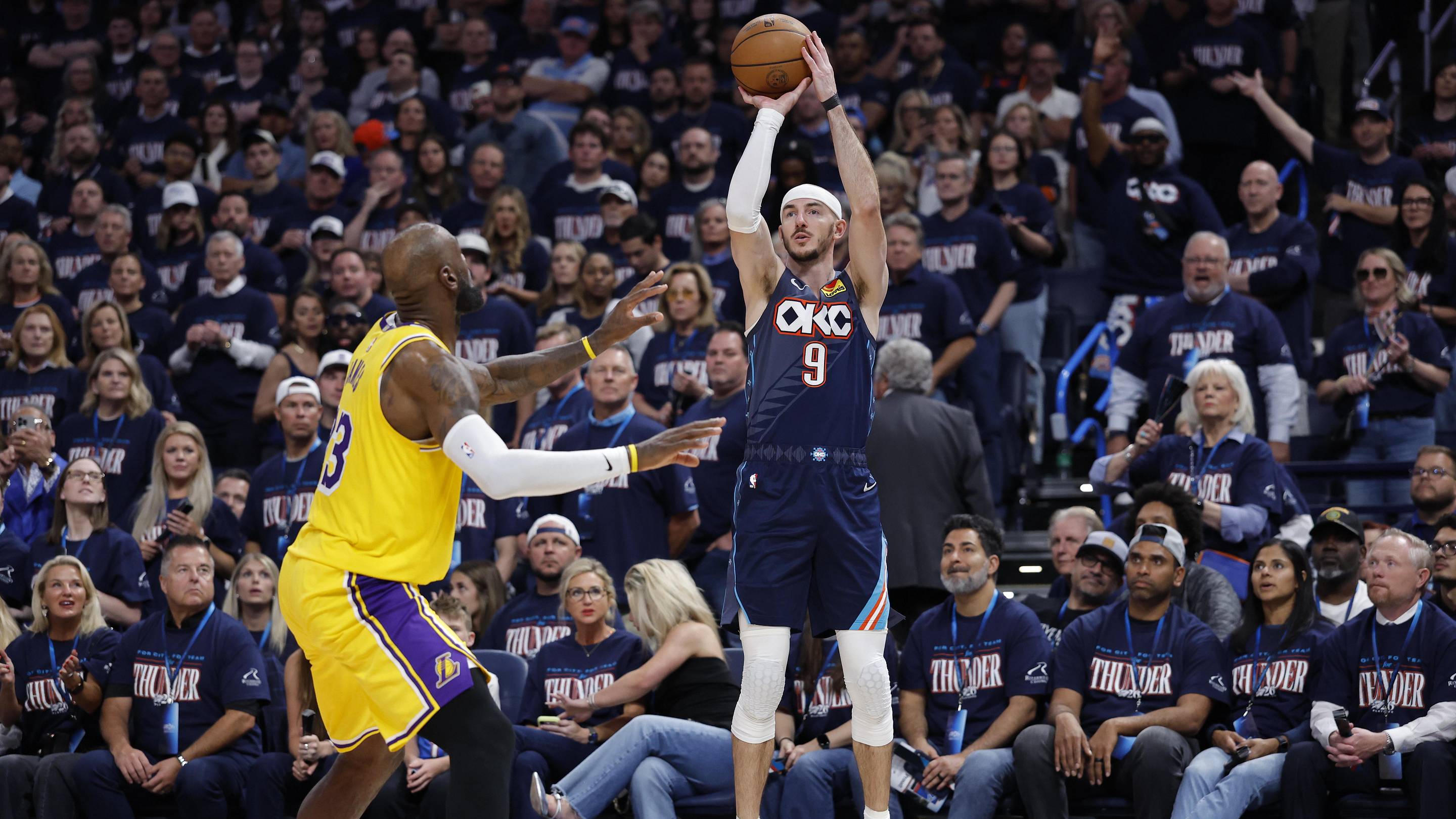 May 7, 2026; Oklahoma City, Oklahoma, USA; Oklahoma City Thunder guard Alex Caruso (9) shoots a three point basket as Los Angeles Lakers forward LeBron James (23) defends in the second half during game two of the second round of the 2026 NBA Playoffs at Paycom Center. Mandatory Credit: Alonzo Adams-Imagn Images