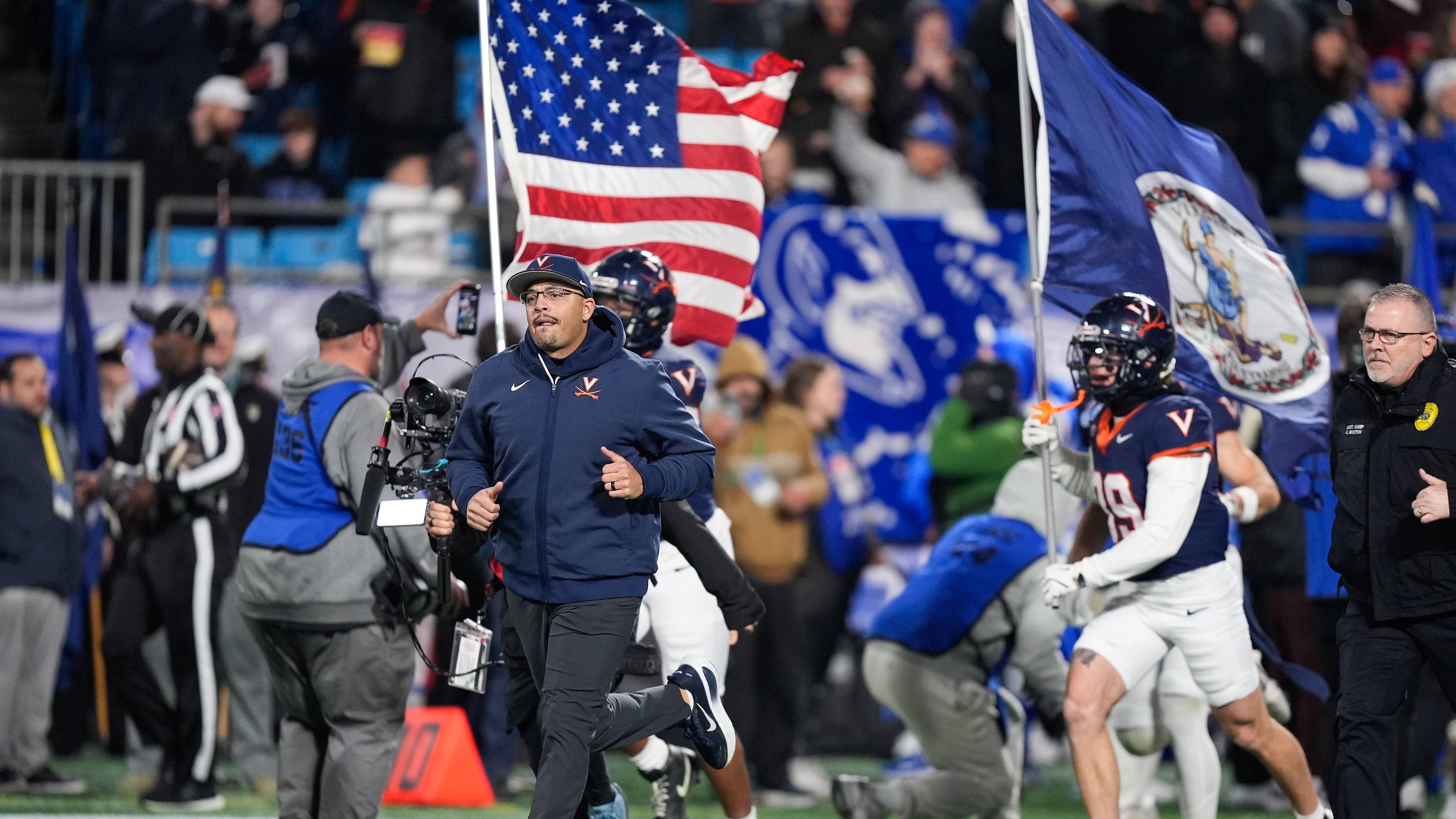 Dec 6, 2025; Charlotte, NC, USA; Virginia Cavaliers head coach Tony Elliott enters the field before the game against the Duke Blue Devils during the 2025 ACC Championship game at Bank of America Stadium. Mandatory Credit: Jim Dedmon-Imagn Images