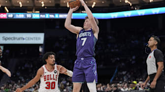 Dec 12, 2025; Charlotte, North Carolina, USA; Charlotte Hornets guard Kon Knueppel (7) shoots a three over Chicago Bulls guard Tre Jones (30) during the second quarter at Spectrum Center. Mandatory Credit: Jim Dedmon-Imagn Images