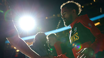 Trae Young walks onto the floor after being introduced as a starter in Atlanta's Play-In matchup against the Heat last season.
