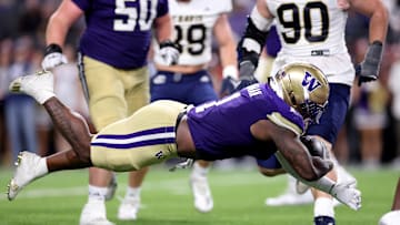 Washington Huskies running back Jonah Coleman dives into the endzone during the team's 70-10 victory over the UC Davis Aggies. Coleman finished the game with a program record-equaling five rushing touchdowns.