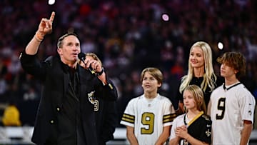 Former QB Drew Brees speaks to fans at Superdome during ceremony for his entry into Saints' Hall of Fame as his family looks on Thursday night at halftime with Saints down 16-3. They lost 33-10 to Denver and coach Sean Payton, formerly Brees' Saints coach.
