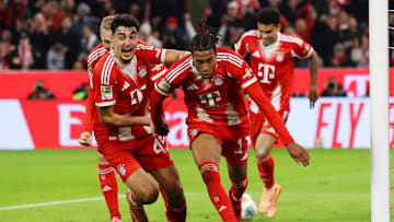Bayern Munich players celebrating Michael Olise's goal against Borussia Dortmund.
