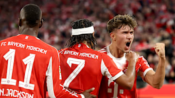 Bayern Munich players celebrating against Bayer Leverkusen.