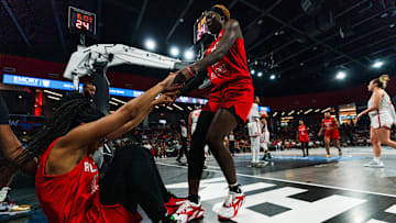 Atlanta Dream All-Star Rhyne Howard helps up teammate Allisha Gray