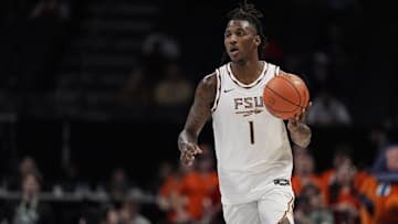 Mar 11, 2025; Charlotte, NC, USA;  Florida State Seminoles guard Jamir Watkins (1) brings the ball up court against the Syracuse Orange during the second half at Spectrum Center. Mandatory Credit: Jim Dedmon-Imagn Images