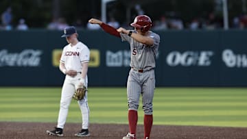 Jun 1, 2024; Norman, OK, USA; Oklahoma Sooners infielder Michael Snyder (5) gestures after advancing to second base during the second inning of an NCAA Division I Baseball Championship game between the UConn Huskies and the Oklahoma Sooners at L. Dale Mitchell Park. Credit: Alonzo Adams-USA TODAY Sports