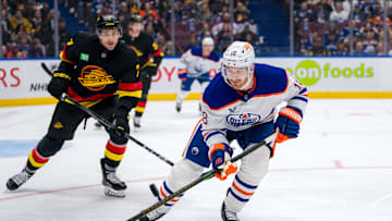 Vancouver Canucks defenseman Carson Soucy (7) watches Edmonton Oilers forward Zach Hyman (18)