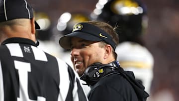 Oct 18, 2025; Auburn, Alabama, USA; Missouri Tigers head coach Eli Drinkwitz talks to a game official during the first quarter against the Auburn Tigers at Jordan-Hare Stadium. Mandatory Credit: John Reed-Imagn Images
