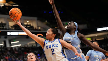 Mar 28, 2025; Birmingham, AL, USA; Duke Blue Devils guard Vanessa de Jesus (2) slips past North Carolina Tar Heels center Maria Gakdeng (5) for two points at Legacy Arena in the Sweet 16.