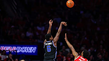 Feb 22, 2025; Tucson, Arizona, USA; BYU Cougars forward Kanon Catchings (6) shoots a three-point shot over Arizona Wildcats forward Tobe Awaka (30) during the second half at McKale Center. Mandatory Credit: Aryanna Frank-Imagn Images